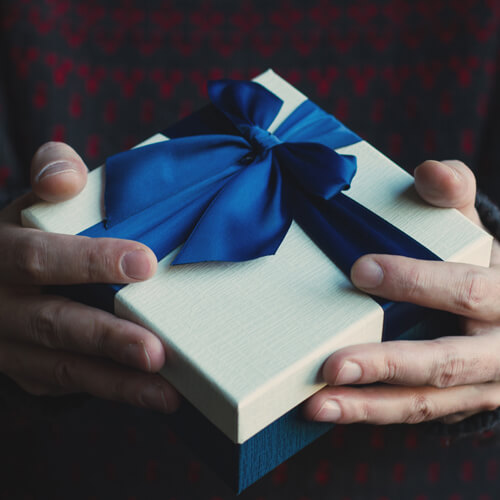 Man holding a boxed gift